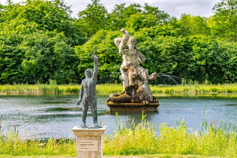 Bronze sculpture of painter's trunk and mirror pond with Hercules in the baroque Neuwerkgarten, Museum Island at Gottorf Castle, City of Schleswig, Schleswig-Holstein, Germany