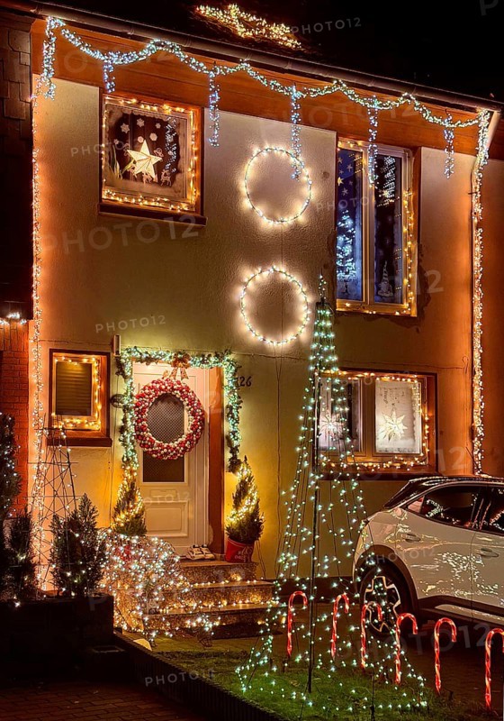 Christmassy kitschy illuminated façade of a row house in Gelsenkirchen-Ückendorf in the evening, Ruhr area, North Rhine-Westphalia, Germany