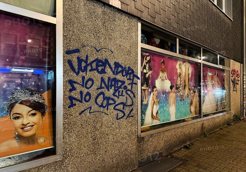 Facade smeared with Ückendorf No Nazis No Cops in one of the poorest cities in Germany, Gelsenkirchen, Ruhr area, North Rhine-Westphalia, Germany