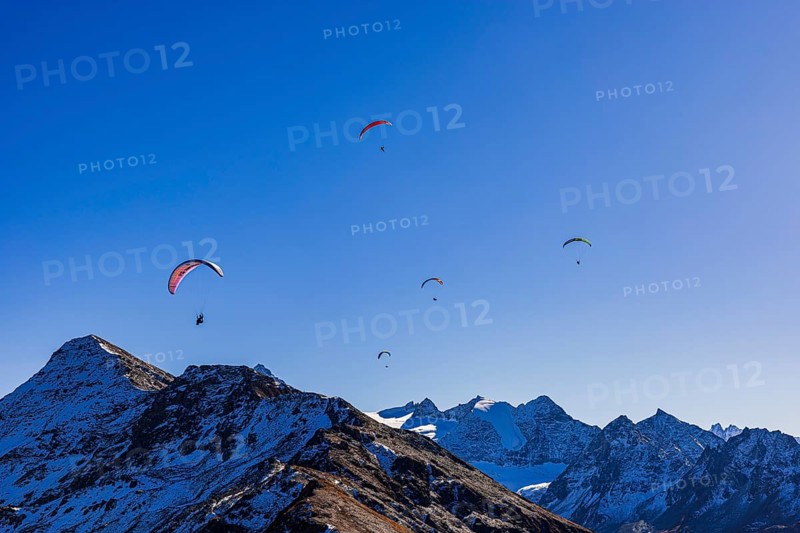 Paragliders fly over the mountains of the Valais Alps, Val d'Anniviers, Valais Alps, Canton of Valais, Switzerland