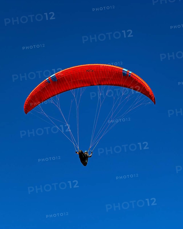 Paragliders against a blue sky, Val d'Anniviers, Valais Alps, Canton of Valais, Switzerland