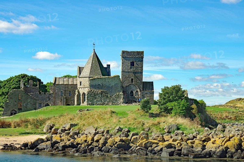 A historic castle on a green field with trees under a blue sky, Inchholm Abbey, Middle Ages, Firth of Forth, Edinburgh, Scotland, Great Britain