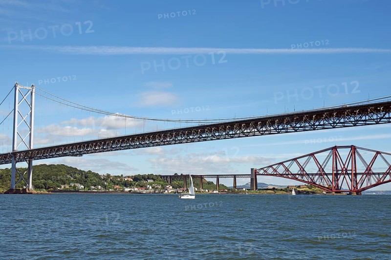 Two distinctive bridges over water with a small sailboat in the foreground, railway bridge and road bridge, Firth of Forth, Edinburgh, Scotland, Great Britain