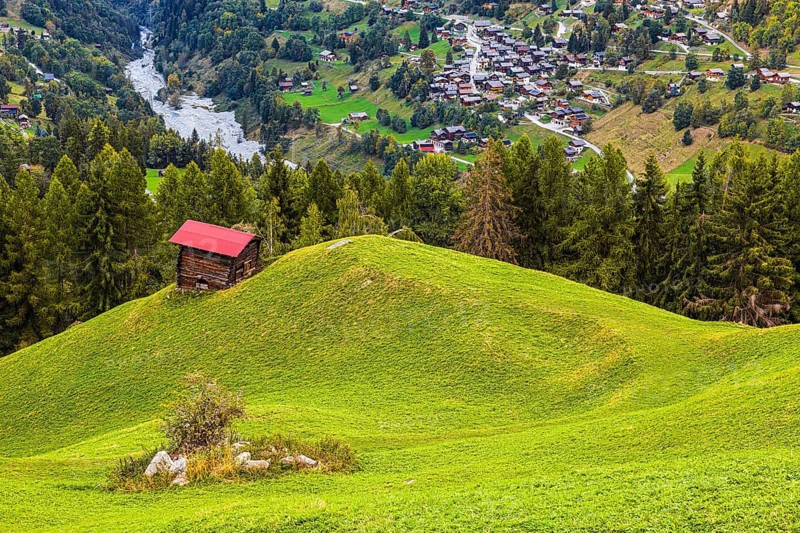 Small alpine hut on a green hill, behind the village of Mission, Val d'Anniviers, Valais Alps, Canton of Valais, Switzerland