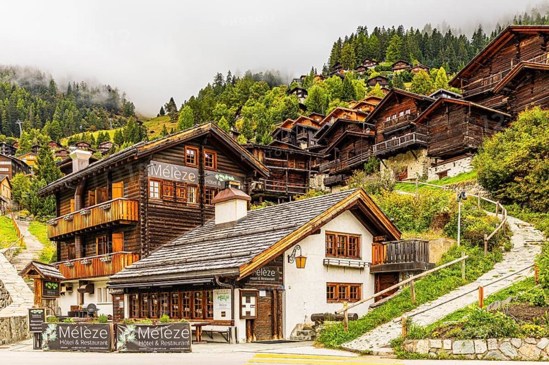 Hotel Restaurant Meleze in front of historic farmhouses, Grimentz, Val d'Anniviers, Valais Alps, Canton of Valais, Switzerland