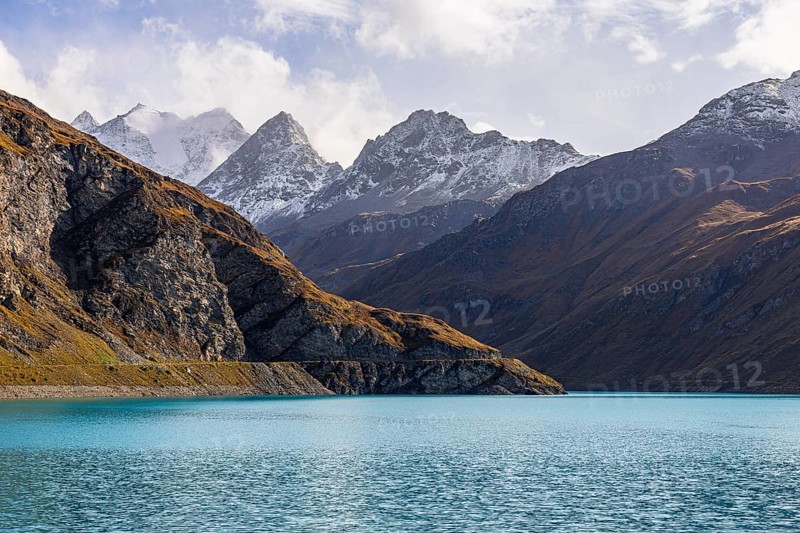 The turquoise Lac de Moiry reservoir, behind the peaks of the Grand Cornier, Tete Blanche and Pointe Moiry mountains, Val d'Anniviers, Valais Alps, Canton of Valais, Switzerland