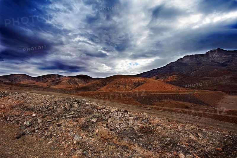 Dramatic mountain landscape with cloudy sky and rugged terrain, Pajara Fuerteventura, Canary Island