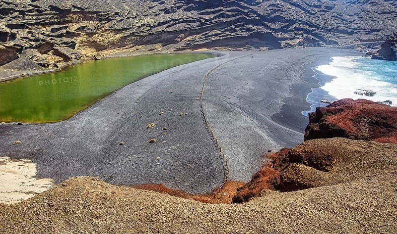 Volcanic landscape with green lagoon and rugged coastline, El Golfo Lanzarote, Canary Island