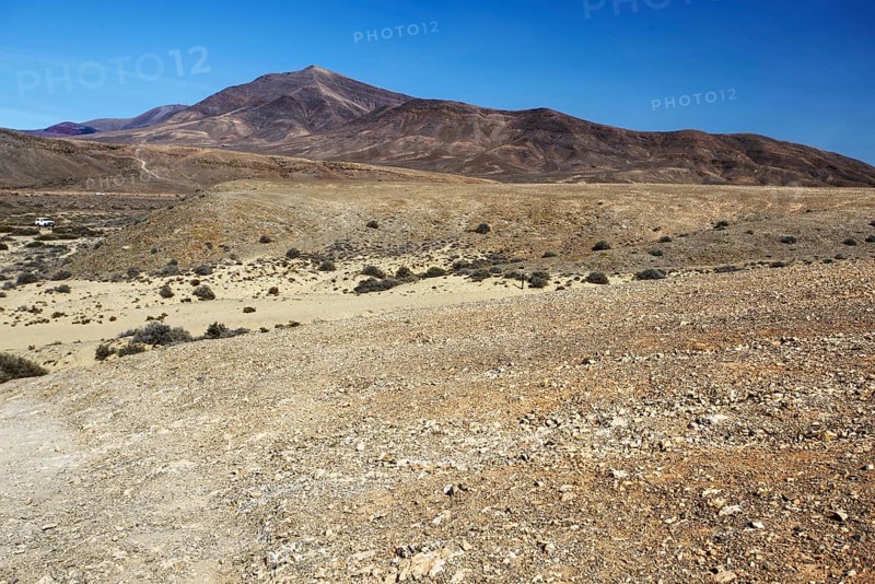 Wide, dry hilly landscape with a distant mountain under clear skies, Playa Blanca Lanzarote, Canary Island