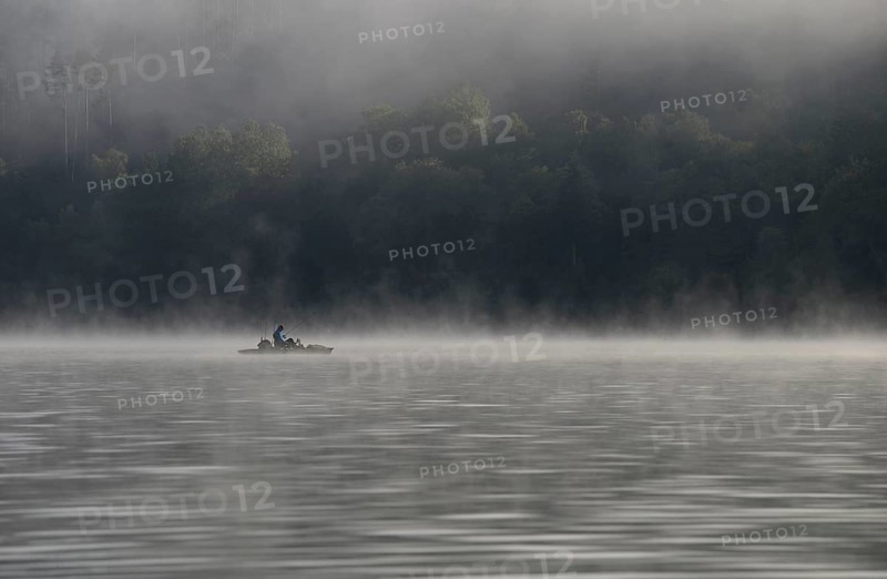Hennesee, fog, rising clouds of fog, anglers in the boat, Hennetalsperre, Sauerland-Rothaargebirge nature park Park, North Rhine-Westphalia, Germany