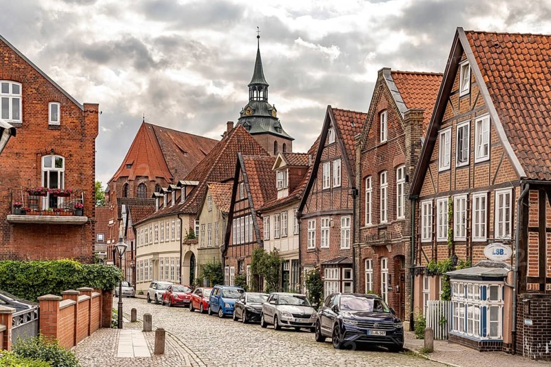 Half-timbered houses in the historic street Auf dem Meere and the St. Michaelis church in the Hanseatic city of Lüneburg, Lower Saxony, Germany
