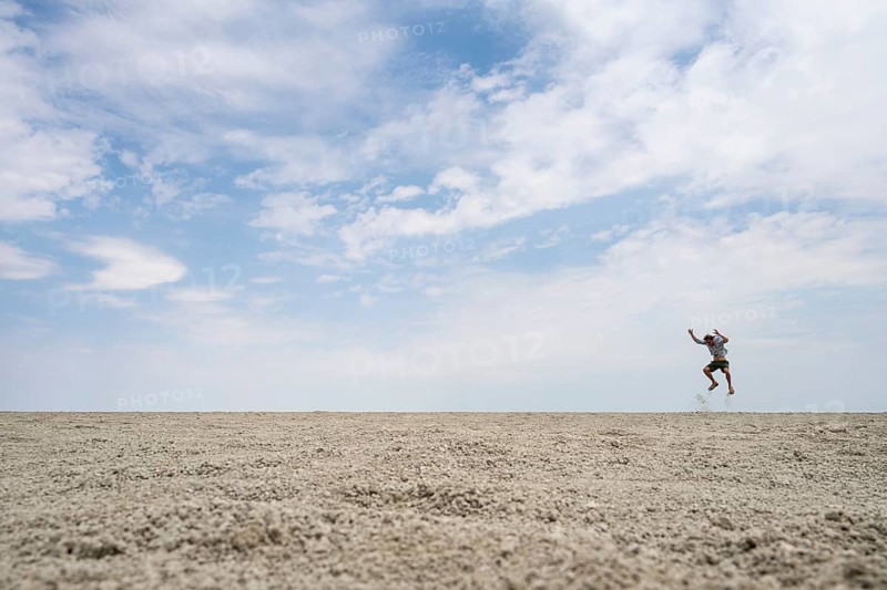 Symbolic picture, abstract, man jumping on the Etosha pan, salt pan, Etosha National Park, Namibia