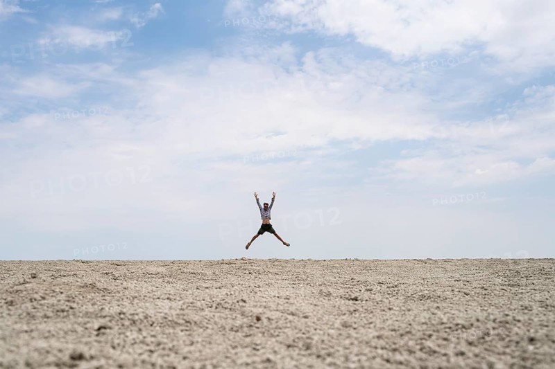 Abstract, man jumping on the Etosha pan, salt pan, Etosha National Park, Namibia