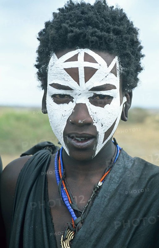 Portrait of a Maasai boy with face painted white on the occasion of his initiation, Ngorongoro Crater, Tanzania, Africa, June 2000, vintage, retro, old, historical