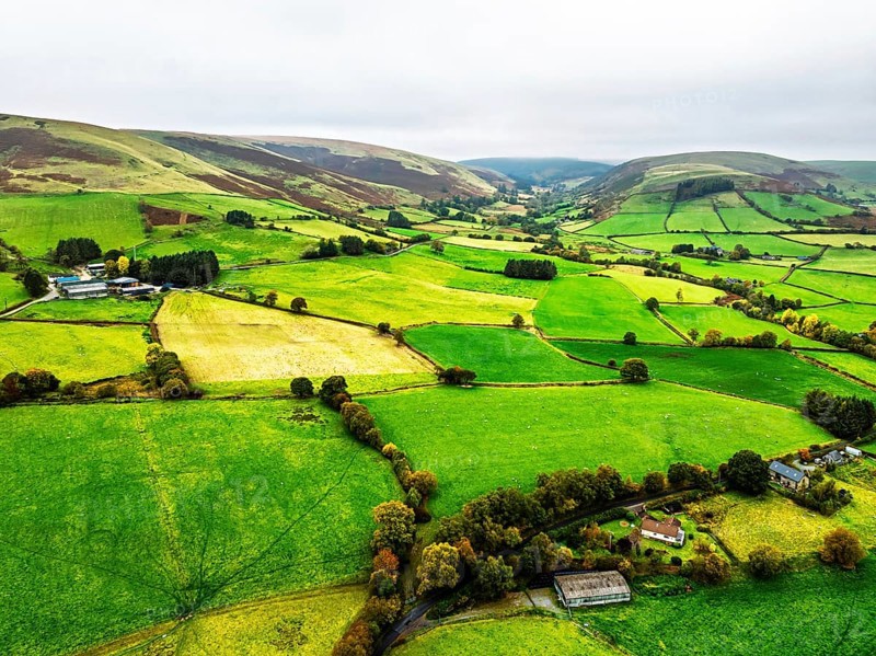 Autumn colours of Farms over River Wye and Road A470 from a drone, Llanidloes, Powys, Montgomeryshire, Wales, UK