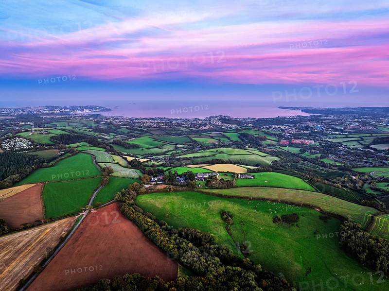 Sunset of Devon Farms and Fields over Berry Pomeroy from a drone, Totnes, England, United Kingdom