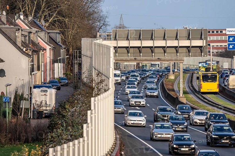 Residential buildings directly on the A40 motorway, noise barrier, heavy traffic near the Essen-Ost motorway junction, view to the west, 6-lane motorway, with 2 bus lanes in the middle, rush hour traffic, North Rhine-Westphalia, Germany