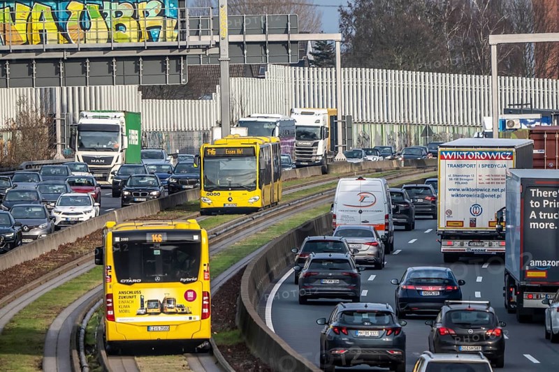 Heavy traffic on the A40 motorway, Ruhrschnellweg, height of the Essen-Ost motorway junction, looking east, 6-lane motorway, with 2 bus lanes in the middle, rush hour traffic, North Rhine-Westphalia, Germany