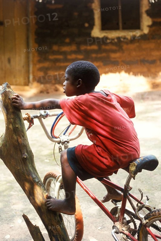 Little boy on a bicycle, Zanzibar, Tanzania, Africa, June 2000, vintage, retro, old, historic