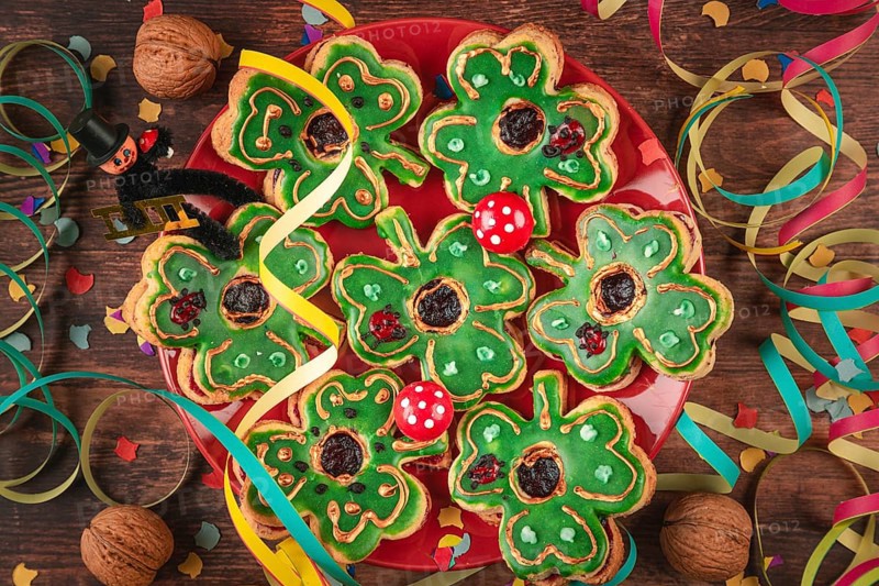 Shamrock shaped cookies with green icing and decoration for New Year