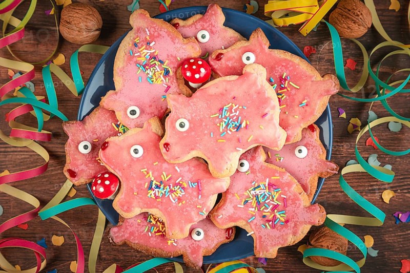 Pig-shaped cookies with pink icing and decoration for New Year's Eve