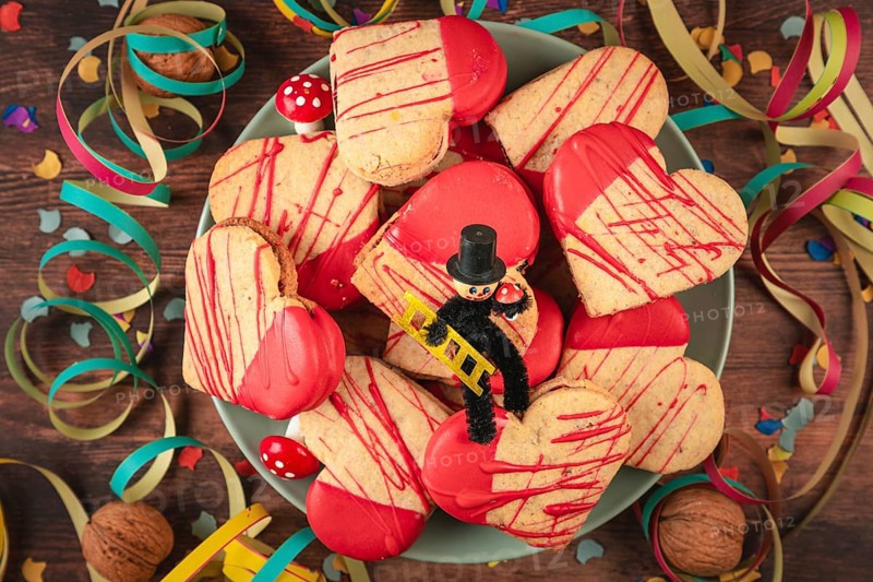 Heart-shaped cookies with red icing and decoration for New Year