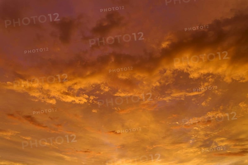A dramatic orange and gold sky at sunrise, cloud formations create an atmospheric atmosphere, Miltenberg, Spessart, Bavaria, Germany