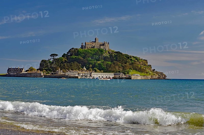 A castle on a hill overlooks the sea with gentle waves, Saint Michael's Mount, Pencanze, Cornwall, United Kingdom