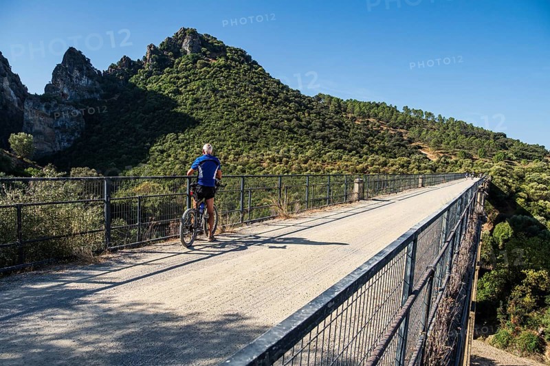 Cyclist takes a break, Viaducto de Zaframagón, cycle path Via Verde de la Sierra, Puerto Serrano to Olvera, old railroad track, cycle path on bridge, near village Coripe, Andalusia, Spain
