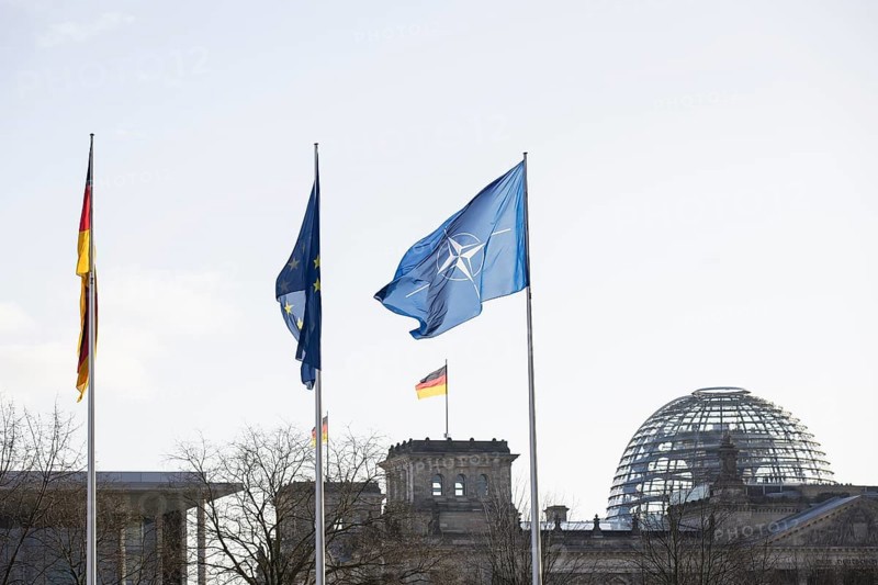 Flags of the Federal Republic of Germany, the EU and NATO in front of the Reichstag building, Berlin, 11.12.2025