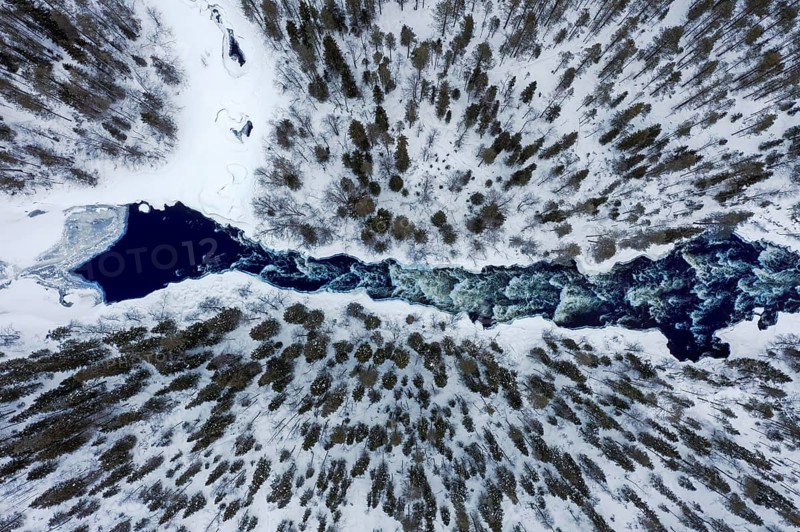 Aerial view over rapids in the river Kitkajoki in winter, Oulanka National Park, Northern Ostrobothnia / Norra Österbotten, Finland