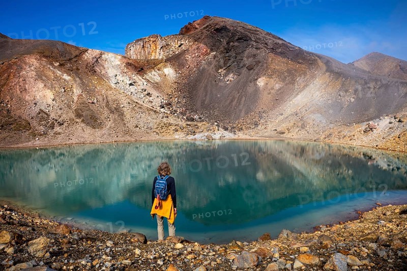 A hiker at one of the Emerald Lakes and Red Crater, Panorama, Tongariro alpine crossing, Tongariro National Park, North Island, New Zealand