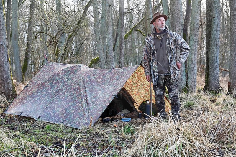 Camp of a nature photographer, nature photographer in front of his camouflage camp in the Erlenbruch Forest, Peenetal nature park Park, Mecklenburg-Western Pomerania, Germany