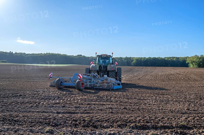 Field treatment of the agricultural cooperative with a large tractor with harrow, Othenstorf, Mecklenburg-Western Pomerania, Germany