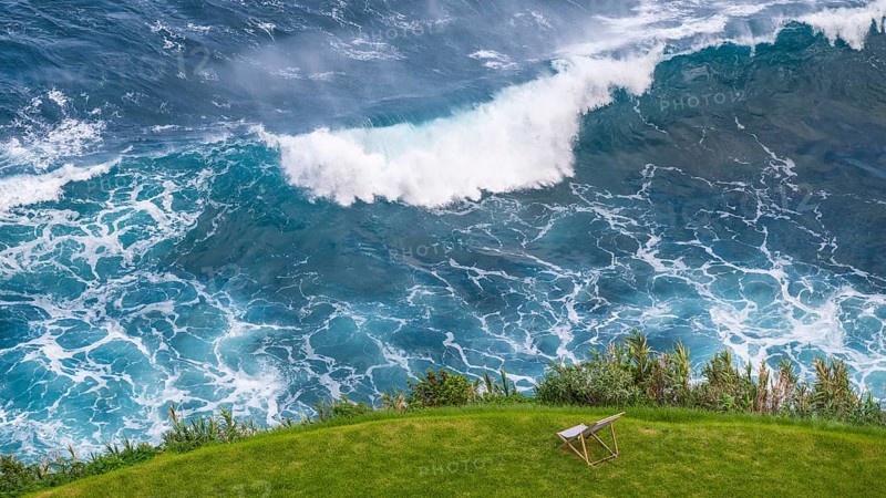 Deckchair in a meadow off coast with waves in the sea, beautiful view, Madeira, Portugal