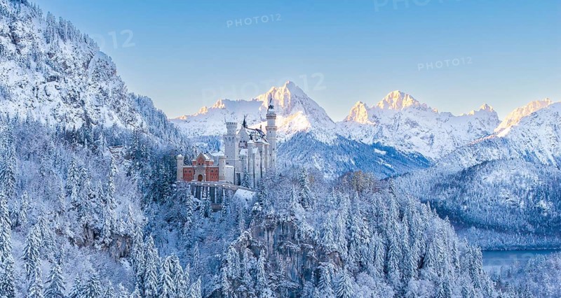 The picturesque Neuschwanstein Castle in an atmospheric, snowy mountain landscape in the morning, Schwangau near Füssen, Ostallgäu, Allgäu, Bavaria, Germany