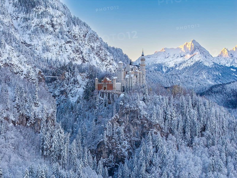 Neuschwanstein Castle against a wintry alpine backdrop in early morning light, Schwangau near Füssen, Ostallgäu, Allgäu, Bavaria, Germany