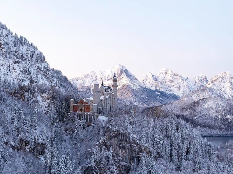Neuschwanstein Castle in a snowy mountain landscape with a gentle evening mood, Schwangau near Füssen, Ostallgäu, Allgäu, Bavaria, Germany