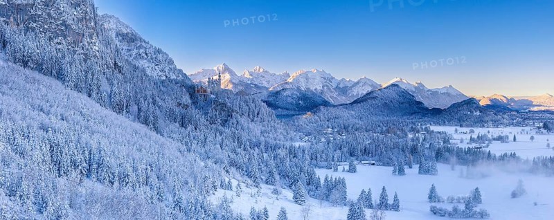 Wide snowy mountain landscape with clear skies and a wide view of the Alps, Neuschwanstein Castle, Schwangau near Füssen, Ostallgäu, Allgäu, Bavaria, Germany