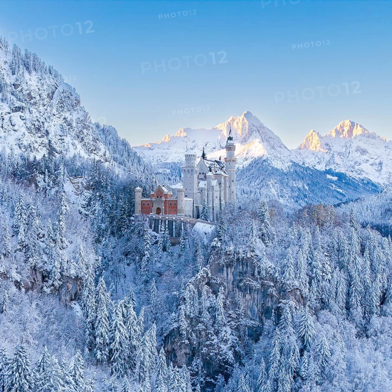 The enchanting Neuschwanstein Castle in a symmetrical, snowy mountain landscape, Schwangau near Füssen, Ostallgäu, Allgäu, Bavaria, Germany