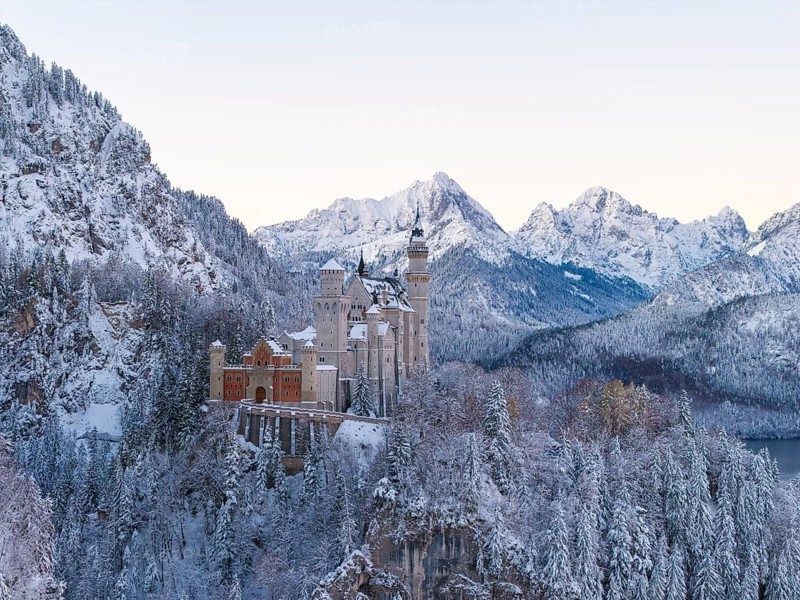 Neuschwanstein Castle rises majestically in a snowy alpine landscape, Schwangau near Füssen, Ostallgäu, Allgäu, Bavaria, Germany