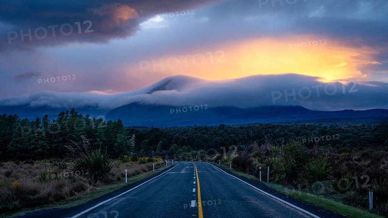 Mount Ngauruhoe in the morning at sunrise with glowing clouds, road SH 47. Tongariro National Park, North Island, New Zealand