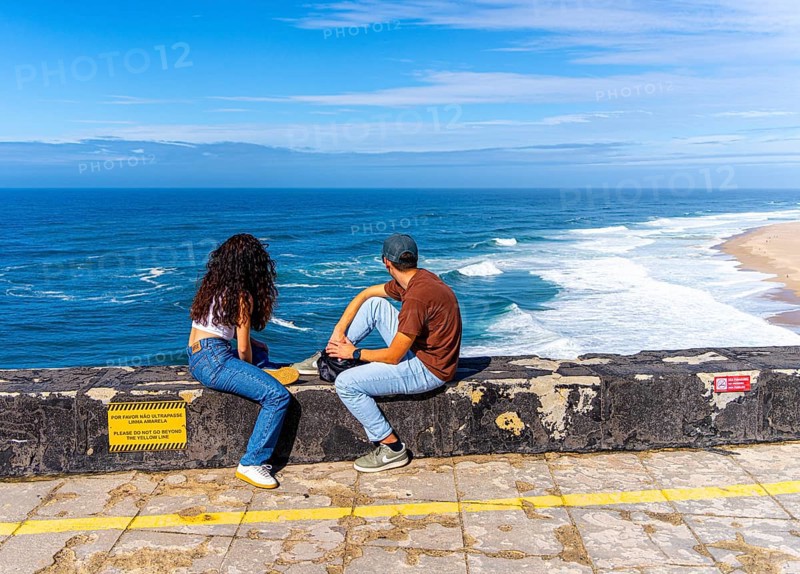 Tourists on the platform of Farol de Nazare lighthouse, Portugal
