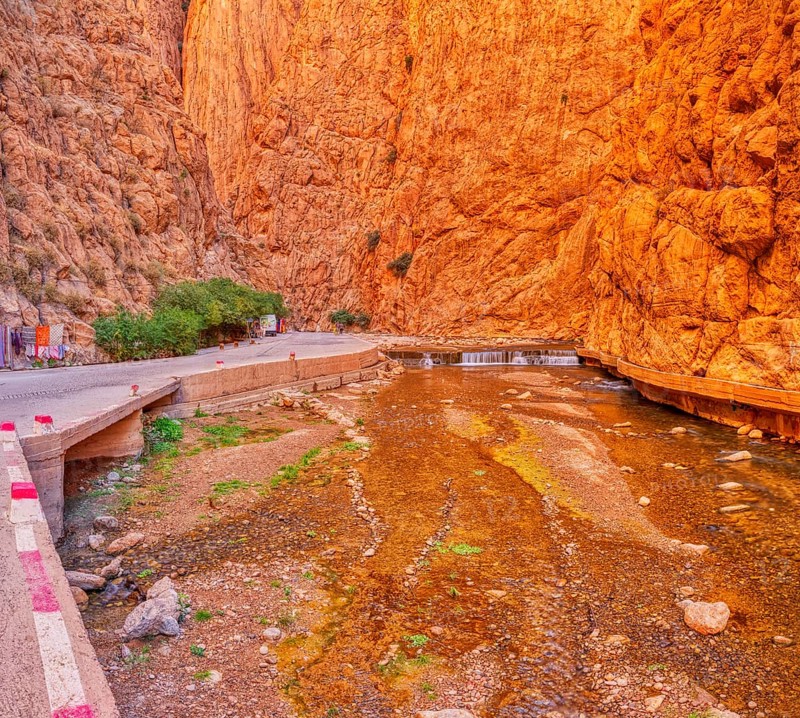 Impressive gorge with orange cliffs and a watercourse in the middle, Todra Gorge in Morocco