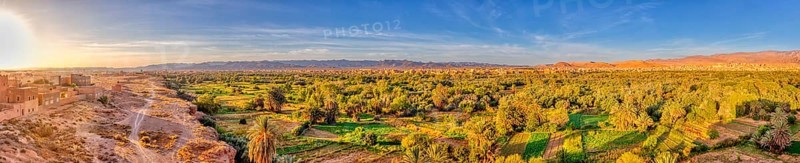 Green oasis landscape at dusk with wide sky and sunset, Tinghir in Morocco