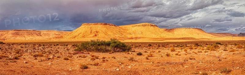 Extensive desert panorama with sandy hills and a cloudy sky, Tinghir in Morocco