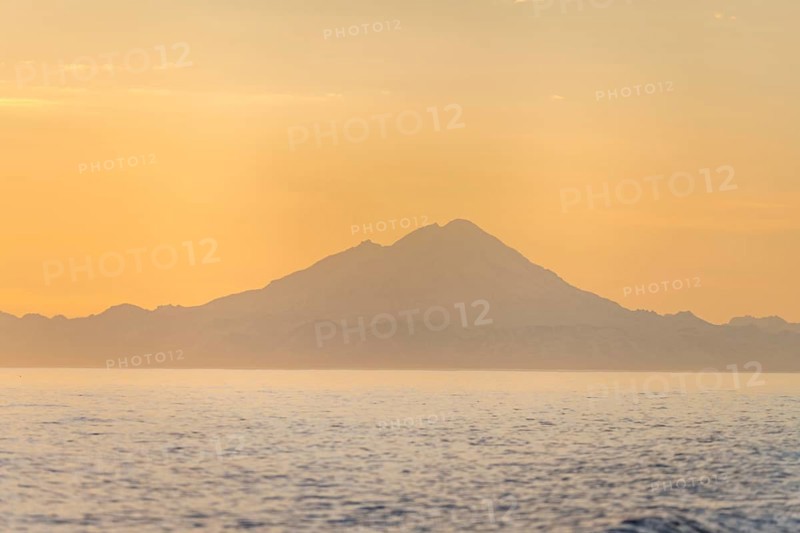 View of Cook Inlet on white mountain peaks of Mount Redoubt at sunset, midnight sun, Aleutian mountains, Anchor Point, Anchor River State Recreation Area, Alaska, USA