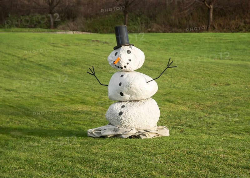 Snowman on green lawn at green winter in Ystad, Skåne County, Sweden, Scandinavia