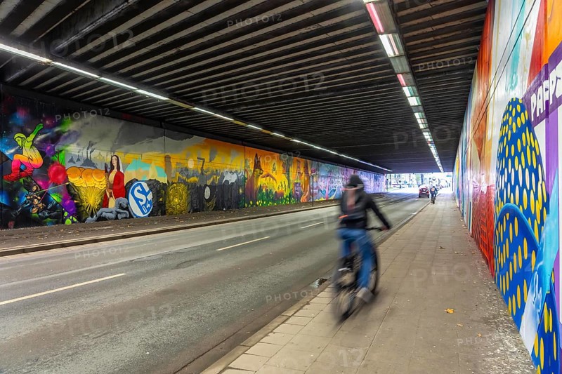 Huge street art pictures in a road tunnel in Gelsenkirchen, the approximately 120 meter long railway underpass of Wickingstraße was extensively painted and sprayed on both sides by 11 Gelsenkirchen graffiti artists and collectives, over a total length of 174 meters, the wall paintings showed motifs from Gelsenkirchen history, from economy, coal, steel, soccer, Schalke 04, culture, life, to the 150.year-old city Anniversary on 29.11.25, North Rhine-Westphalia, Germany