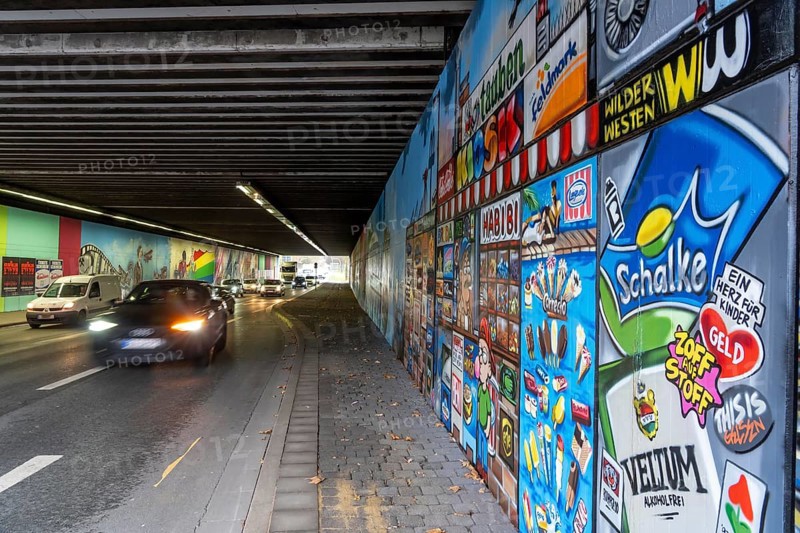 Huge street art pictures in a road tunnel in Gelsenkirchen, the approximately 120 meter long railway underpass of Wickingstraße was extensively painted and sprayed on both sides by 11 Gelsenkirchen graffiti artists and collectives, over a total length of 174 meters, the wall paintings showed motifs from Gelsenkirchen history, from economy, coal, steel, soccer, culture, life, on the 150th anniversary of the city on 29.11.11.25, North Rhine-Westphalia, Germany